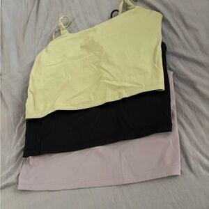 women’s green, black, and purple crop camisole tops